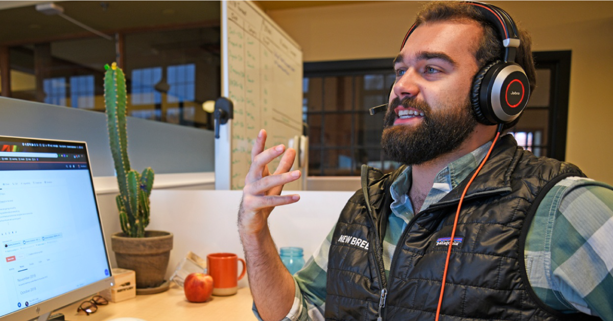 New Breed client success manager speaks on the phone.