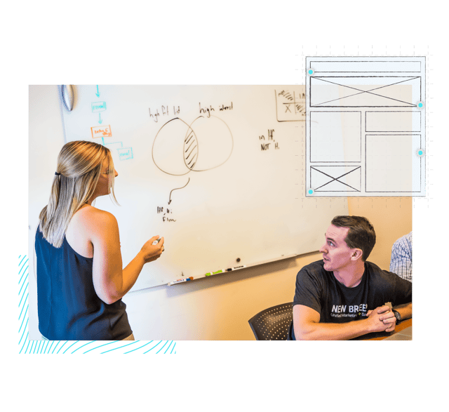 New Breed team draws website wireframes on a whiteboard.