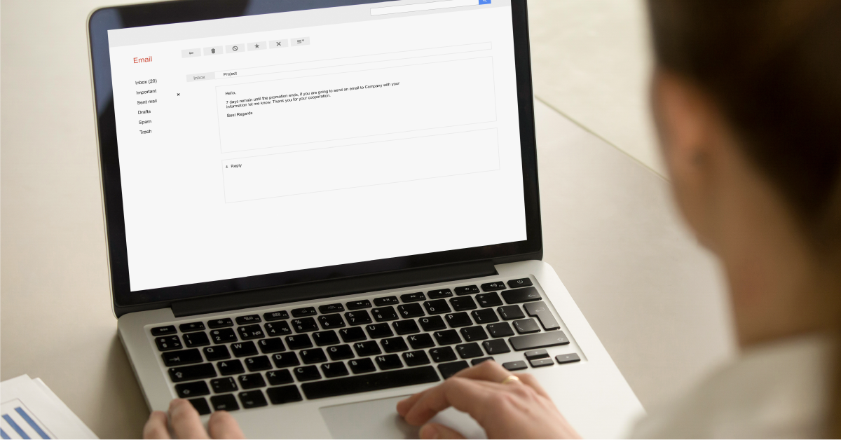 Typing out a marketing email on the computer.