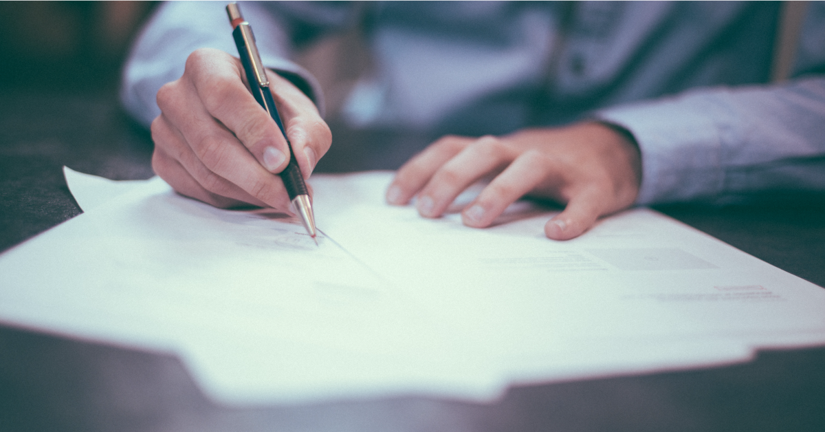 Person signs a sales a contract.